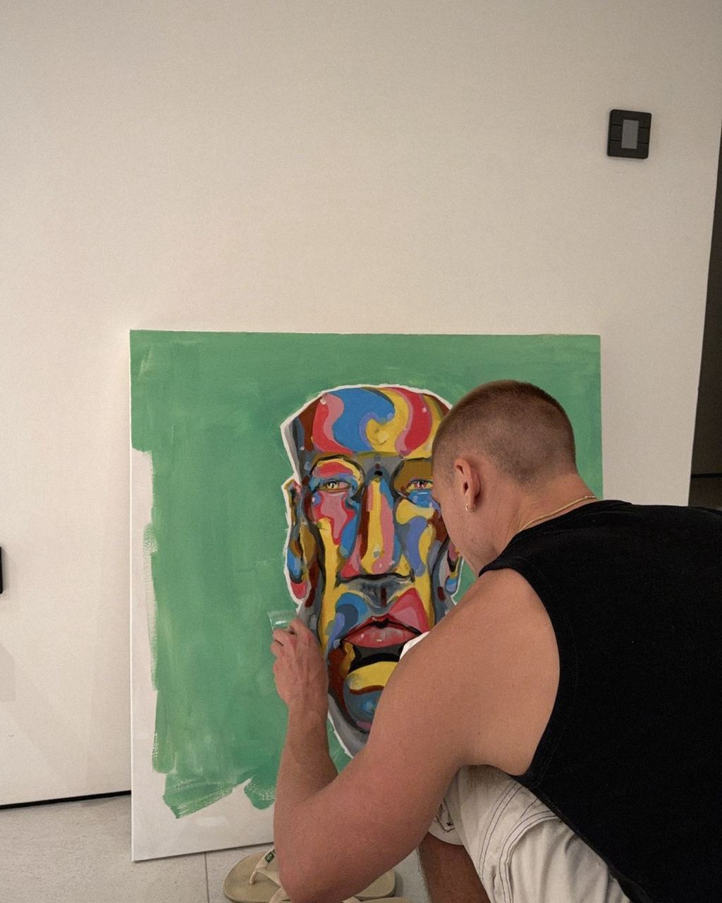 Joshua painting a vivid abstract portrait in the studio